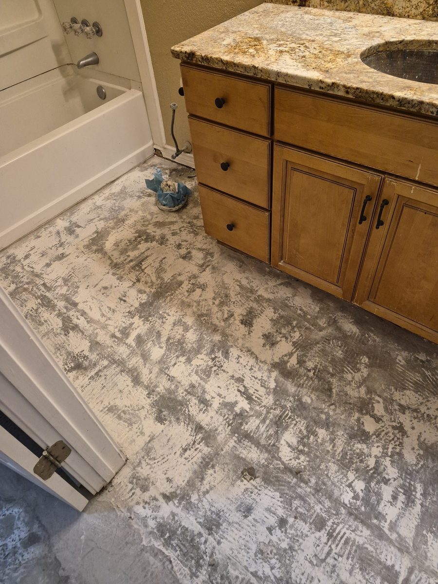 Bathroom with the tile floor removed down to the subfloor