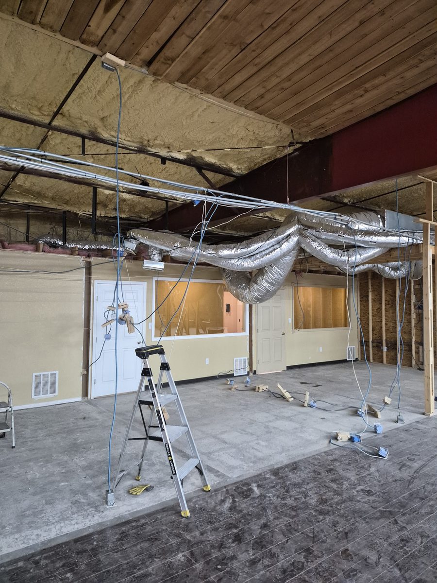 Exposed ductwork and framing in a commercial space mid-demolition