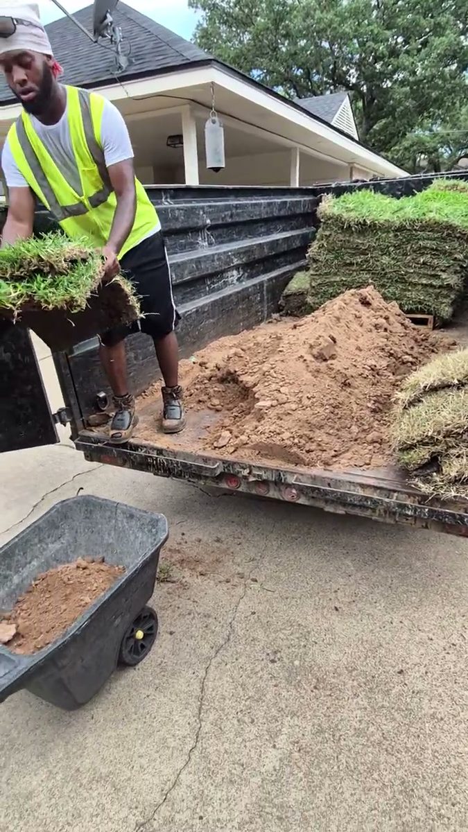 Crew loading cut sod and soil into the dump trailer