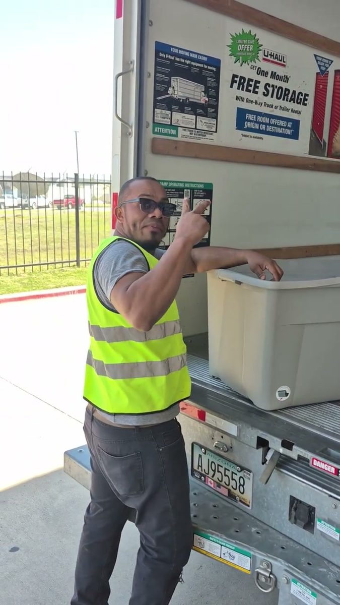 Crew loading storage bins from a unit into the truck