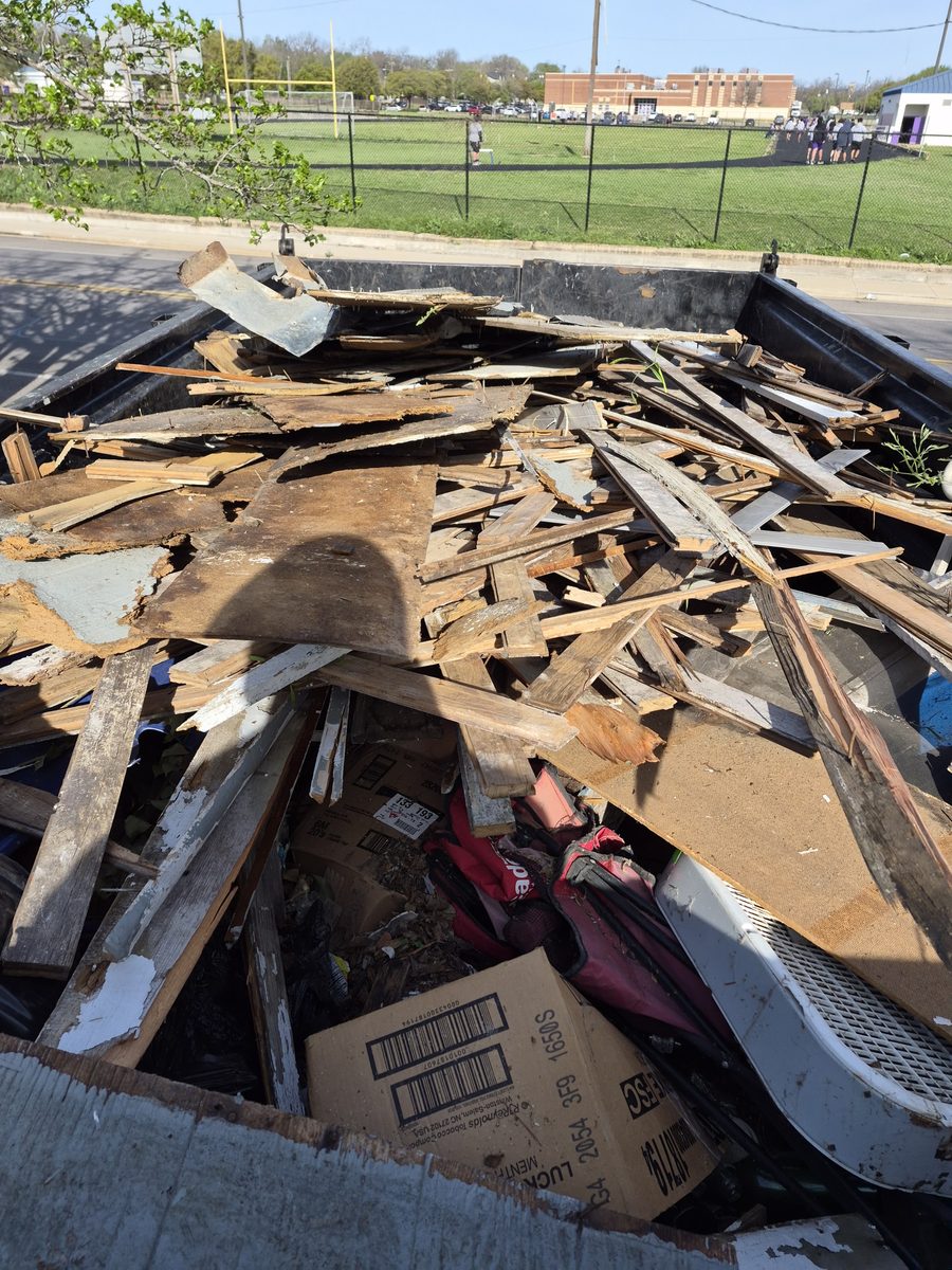 Trailer heaped with lumber, boxes and construction debris