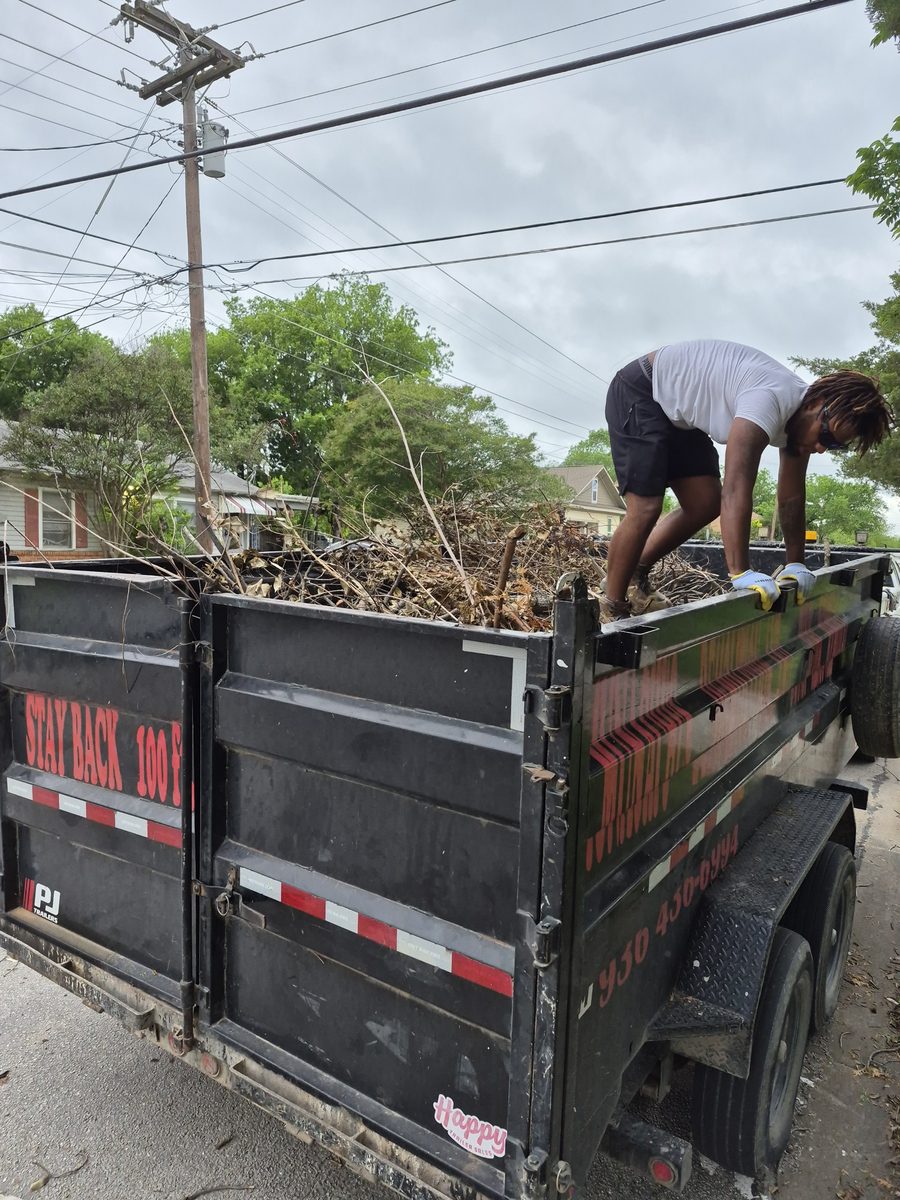 Crew loading brush and yard debris into the dump trailer