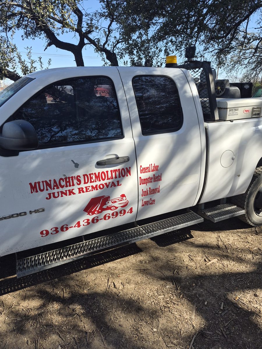 Munachi's Demolition & Junk Removal work truck with services and phone number on the door
